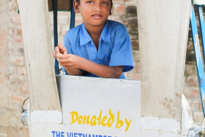 Child in donated rickshaw