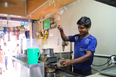 Gopalkrishna makes his chai frothy by pouring it from a height.