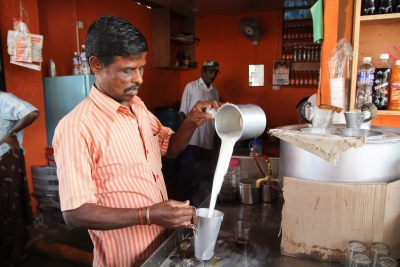 Kaliappal pours a steaming cup of milk.