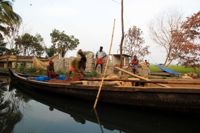 Laborers at work building a house in Kerala's backwaters.