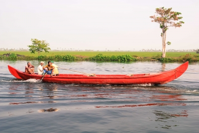 Fishermen float down a waterway near Alleppey, Kerala.